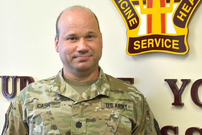 An Army officer poses for a picture.