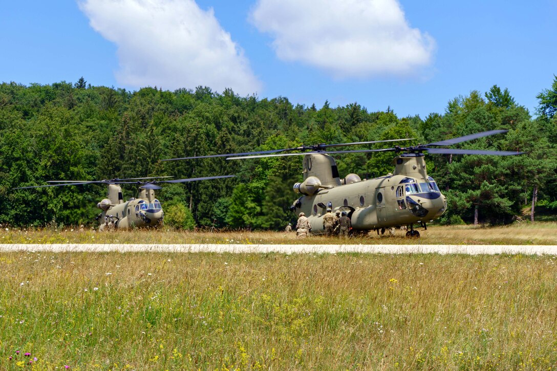 Soldiers prepare to refuel CH-47 Chinook helicopters at a forward area refueling point.