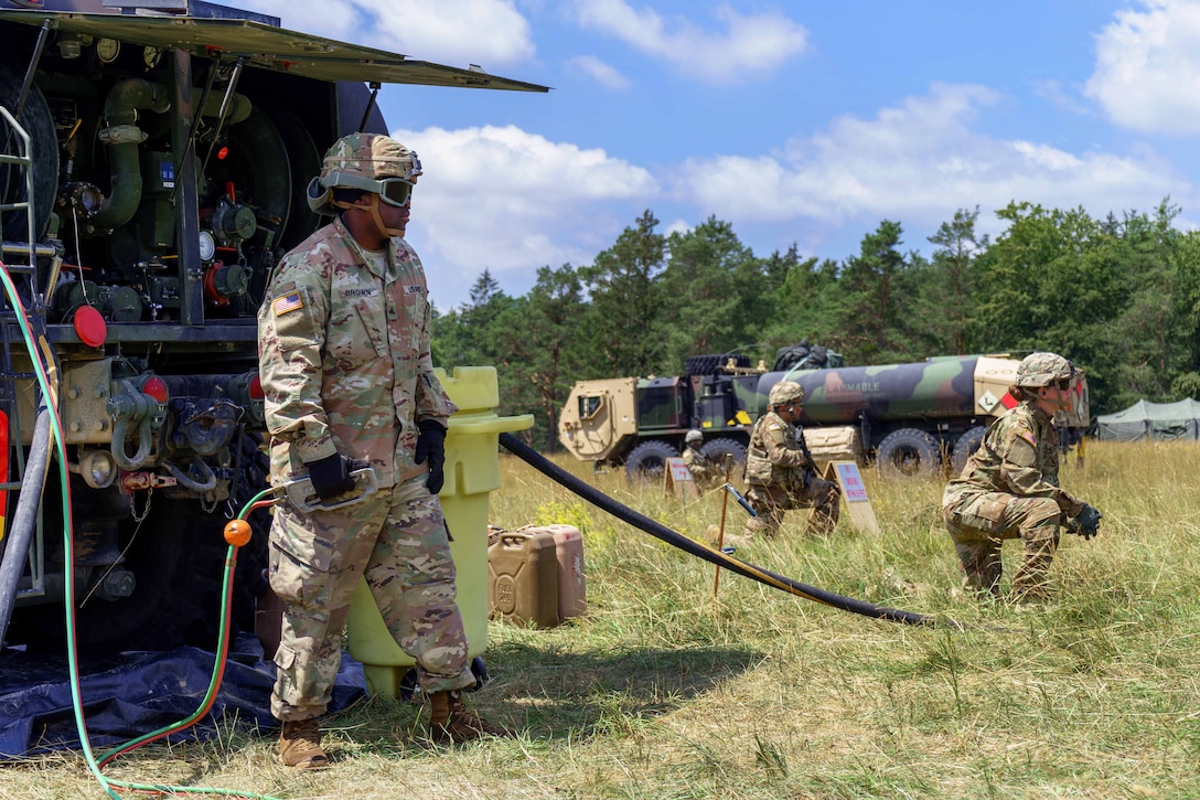 Soldiers stand by fuel trucks.