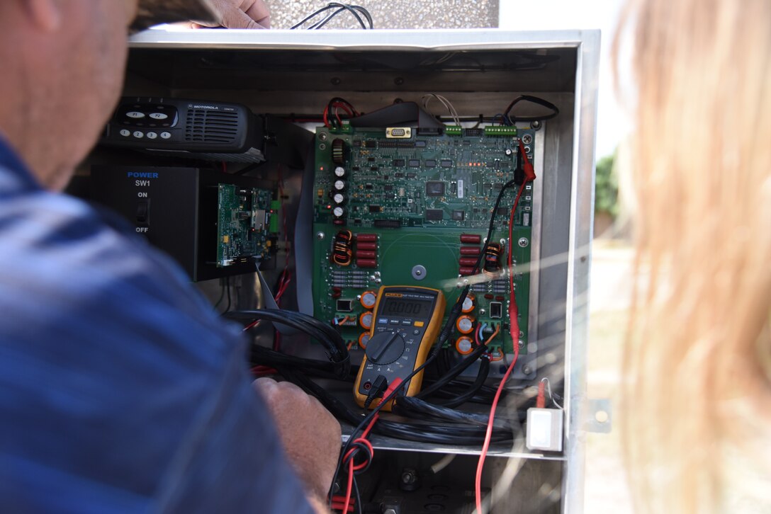 Skip Thomas, communication contractor, shows Sharon Macy, 47th Communications Squadron installation Radio Frequency transmission systems manager, how to update the drivers for the giant voice system at Laughlin Air Force Base, Texas, on June 29, 2018. The giant voice system keeps the base populace alert and informed, causing it to be an integral part of the installation’s safety plan. (U.S. Air Force photo by 1st Lt. Mickel McGann)