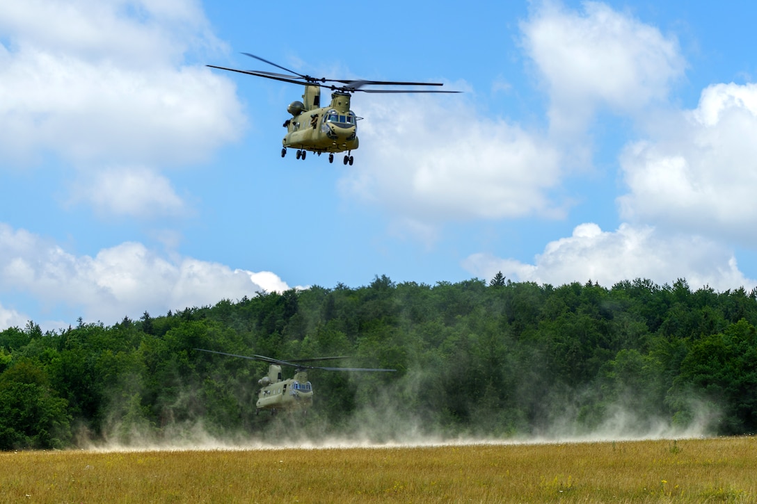 Two Army CH-47 Chinook helicopters take off.