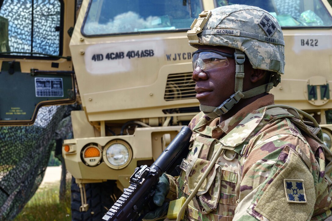 A soldier scans his sector at an entry control point that secures the forward area refueling point.