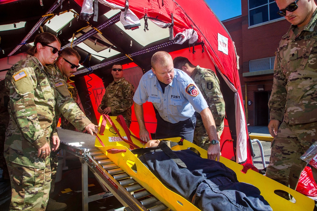 Firefighters train solders to help in an emergency.