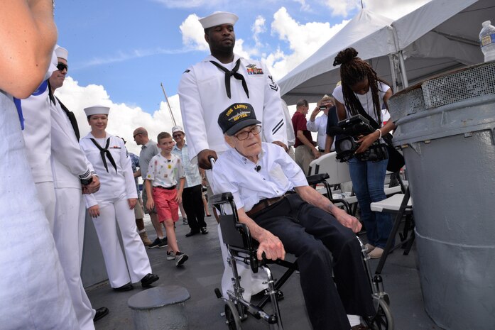 Petty Officer 2nd Class Clinton Leonard, a hospital corpsman serving at Naval Health Clinic Charleston, ushers WWII Veteran Waitman Kapaldo across the deck of the USS Laffey  July 6, 2018, at Patriots Point in Mount Pleasant, S.C.