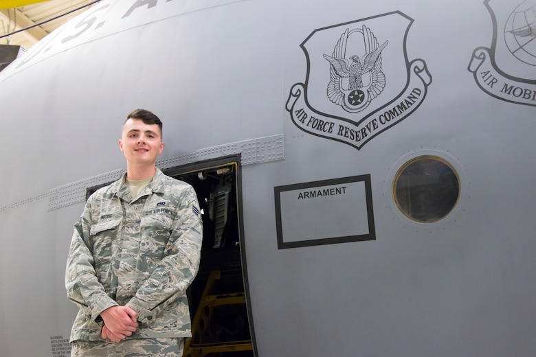 Senior Airman Travis Moore, 302nd Aircraft Maintenance Squadron communication and navigation systems specialist, poses for a photo in front of a C-130 Hercules aircraft Aug. 20, 2018 at Peterson Air Force Base, Colorado. Moore was recently selected to attend the U.S. Air Force Academy Preparatory School through the Air Force’s Leaders Encouraging Airmen Development Program. (U.S. Air Force photo by Staff Sgt. Heather Heiney)
