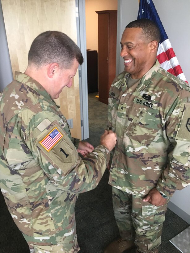 U.S. Army Reserve Maj. Gen. Mark Palzer, commanding general, 79th TSC, promotes Col. Vincent E. Buggs, incoming commander of the 364th ESC, to brigadier general in a ceremony held July 1, 2018, at the Marysville Armed Forces Reserve Center.