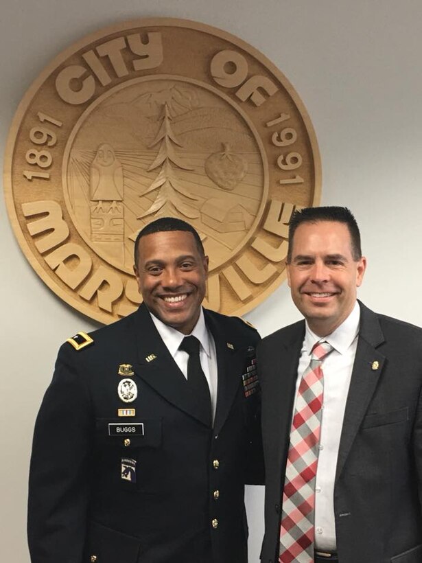 U.S. Army Reserve Brig. Gen. Vincent Buggs, commanding general, 364th Sustainment Command (Expeditionary), and Marysville Mayor Jon Nehring discuss important initiatives aimed to support local community and military families during an office call at Marysville City Hall, July 19, 2018. Families are critical in supporting Readiness as they support our Soldiers in accomplishing their mission.