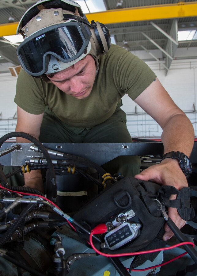 MCAS MIRAMAR -- Sgt. Chris Anchondo, a non-destructive inspector with Marine Heavy Helicopter Squadron (HMH) 466, Marine Aircraft Group 16, 3rd Marine Aircraft Wing, inspects the sleeve and spindle assembly of a CH-53E Super Stallion at Marine Corps Air Station (MCAS) Miramar, Calif., July 12.  HMH-466 is a helicopter squadron consisting of CH-53E Super Stallion transport helicopters based in MCAS Miramar. (U.S. Marine Corps photo by Lance Cpl. Juan Anaya/ Released)