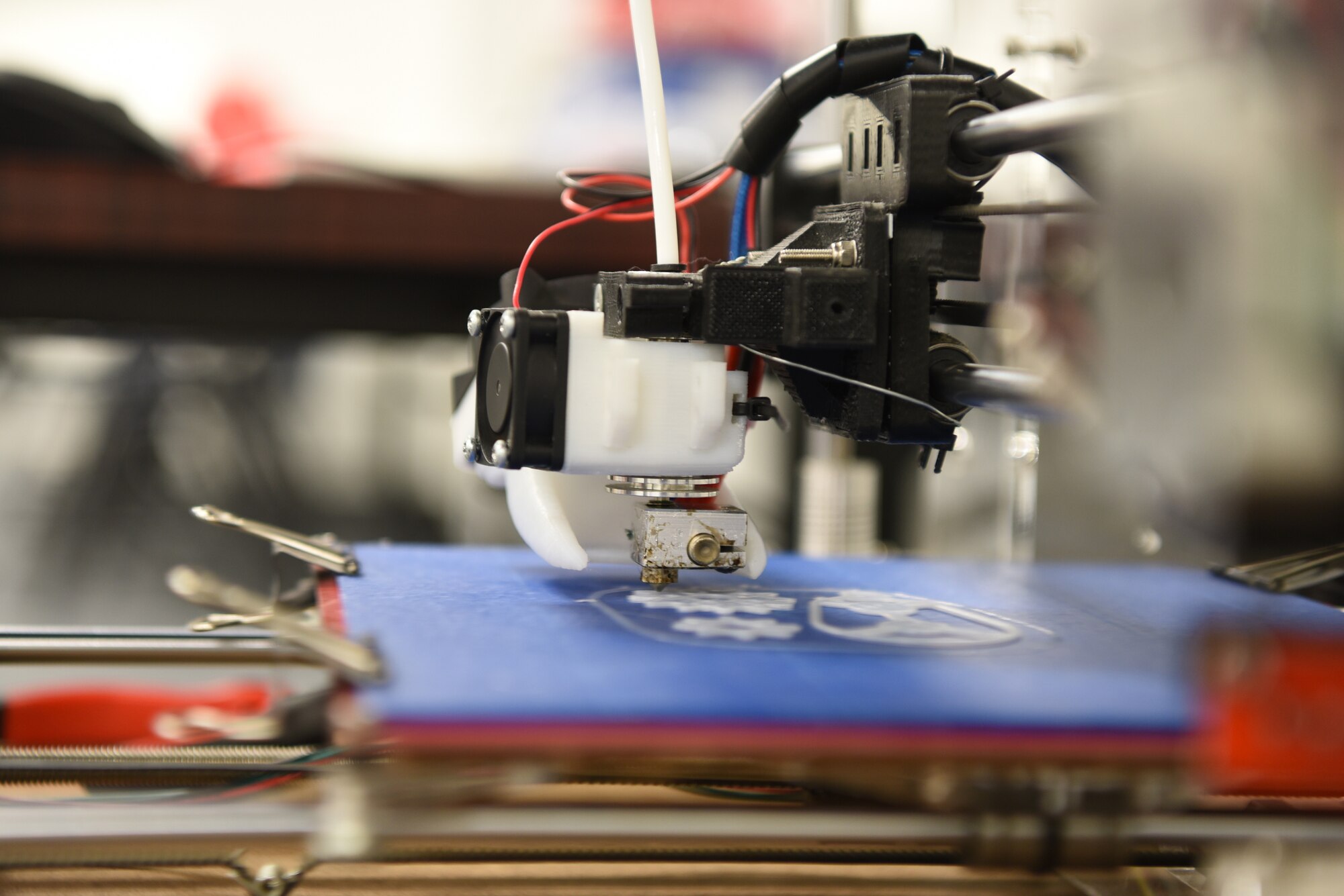 A 3D printer is in the process of making a keychain put together by Tech Sgt. Zachary Zilm, 582nd Operation Support Squadron NCO in charge of group training, July 3, 2018, on F.E. Warren Air Force Base, Wyo. Zilm uses the printer to make prosthetic hands for children. The 3D printed hands allow those children be able to do the simplest tasks a bit easier.