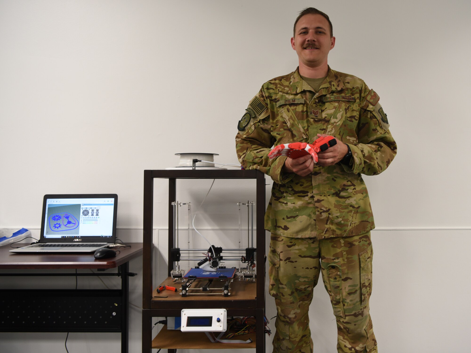 Tech Sgt. Zachary Zilm, 582nd Operation Support Squadron NCO in charge of group training, shows off his first, fully functional, 3D prosthetic hand July 3, 2018, on F.E. Warren Air Force Base, Wyo. Zilm received approval to begin making the prosthetics during the 4th of July holiday. Zilm’s goal now is to put together a team to make the creation process smoother, which would allow more hands to be made.