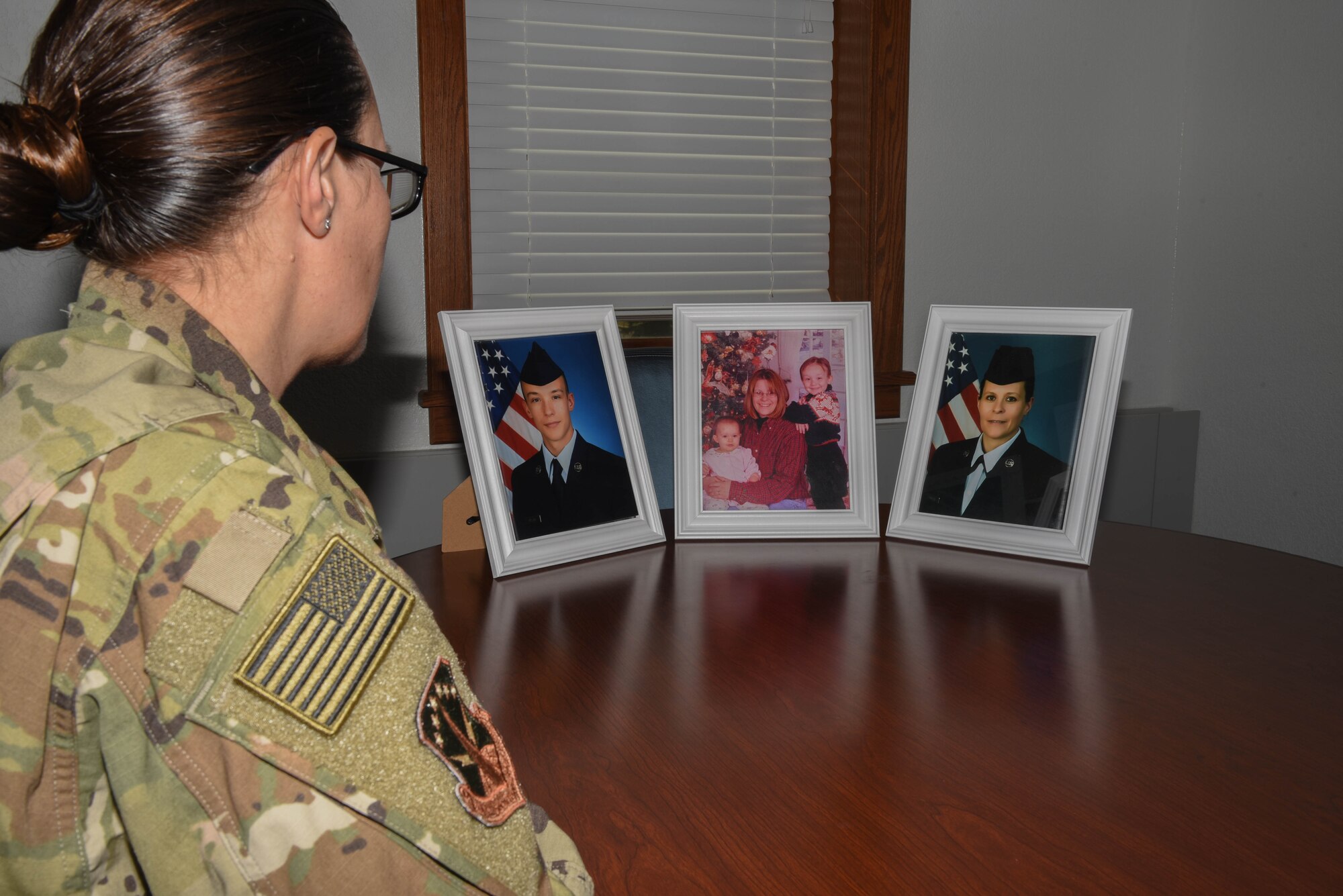 Airman 1st Class Melissa Frazier, 890th Security Forces Squadron member, looks at photos of her family July 2, 2018, on F.E. Warren Air Force Base, Wyo. Melissa wanted to join the Air Force because her grandfather served in World War II and knew the military was a way to make a difference. (U.S. Air Force photo by Airman 1st Class Braydon Williams)