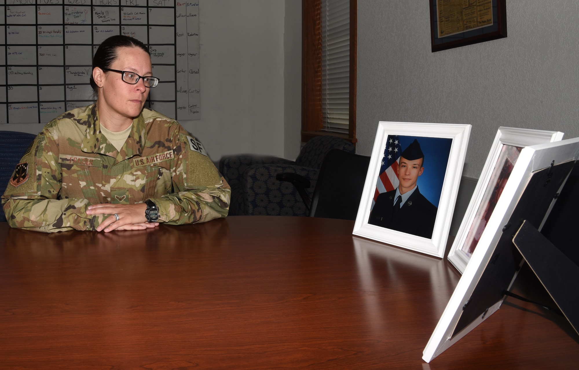 Airman 1st Class Melissa Frazier, 890th Security Forces Squadron member, reflects on her military journey with her son Airman 1st Class Peyton Frazier, 22nd Maintenance Squadron, McConnell Air Force Base, Kansas, July 2, 2018, on F.E. Warren Air Force Base, Wyo. Melissa and Peyton joined the Air Force a little over a year apart, they are a family by birth but wingmen through the oath. (U.S. Air Force photo by Airman 1st Class Braydon Williams)