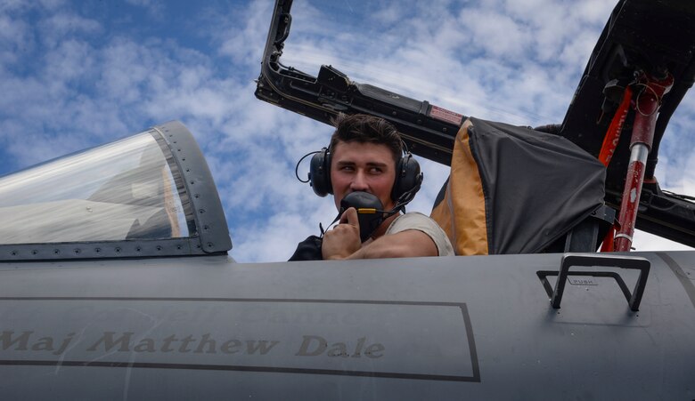 Airman 1st Class Lucas Cupp, F-15E Strike Eagle fighter jet assistant dedicated crew chief assigned to 757th Maintenance Squadron Strike Aircraft Maintenance Unit, uses headset equipment to communicate with a ground member during a defueling process at Nellis Air Force Base, Nevada. Communication between a dedicated crew chief, their ADCC and their pilots is vital for ensuring safety and understanding. (U.S. Air Force photo by Airman Bailee A. Darbasie)