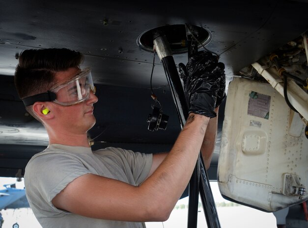 Airman 1st Class Lucas Cupp, assistant dedicated crew chief assigned to 757th Maintenance Squadron Strike Aircraft Maintenance Unit, connects hydraulic lines to an F-15E Strike Eagle at Nellis Air Force Base, Nevada. Despite long hours, hazardous conditions and highly stressful situations, maintainers stay on top of their game to get the mission accomplished. (U.S. Air Force photo by Airman Bailee A. Darbasie)