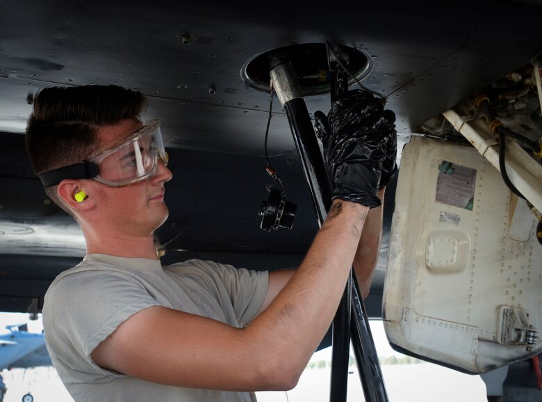 Airman 1st Class Lucas Cupp, assistant dedicated crew chief assigned to 757th Maintenance Squadron Strike Aircraft Maintenance Unit, connects hydraulic lines to an F-15E Strike Eagle at Nellis Air Force Base, Nevada. Despite long hours, hazardous conditions and highly stressful situations, maintainers stay on top of their game to get the mission accomplished. (U.S. Air Force photo by Airman Bailee A. Darbasie)
