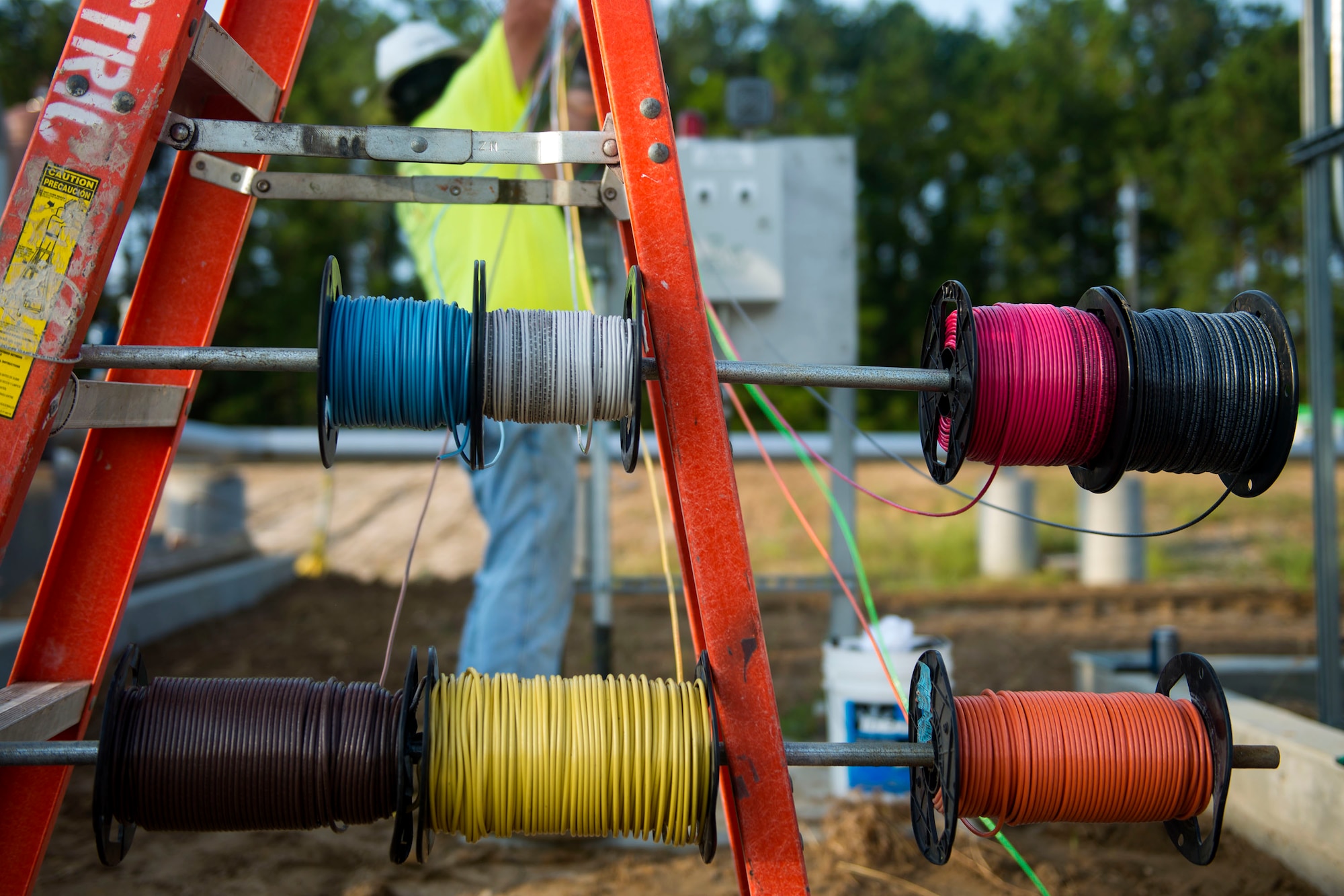 A worker spools conductor wire to a safety switch in the 23d Logistics Readiness Squadron (LRS) fuel yard, July 18, 2018, at Moody Air Force Base, Ga. For the first time since the 1950s, the 23d LRS is modernizing the yard to improve fuel efficiency to enhance operations. (U.S. Air Force photo by Airman 1st Class Erick Requadt)