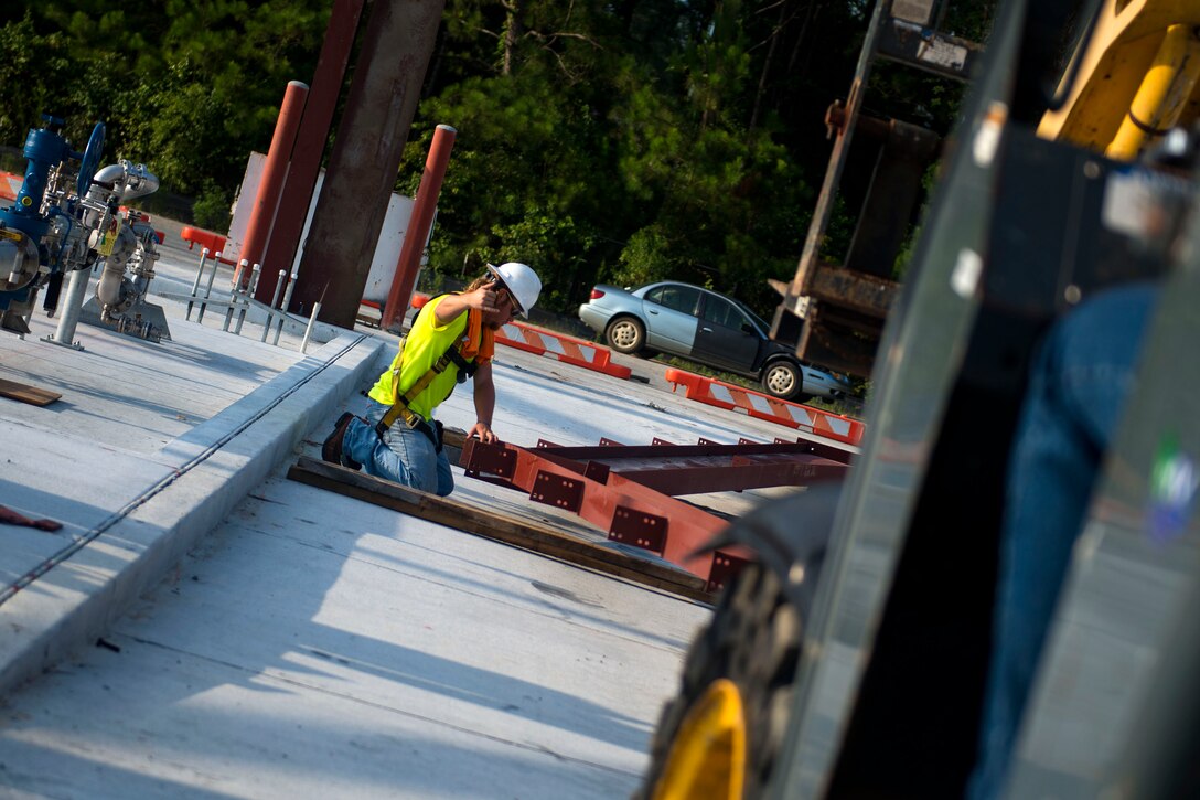 Donovan Graddy, a civilian metal roof installer, guides a rafter for the canopy of the fill stand used for fueling up the trucks in the 23d Logistics Readiness Squadron (LRS) fuel yard, July 18, 2018, at Moody Air Force Base, Ga. For the first time since the 1950s, the 23d LRS is modernizing the yard to improve fuel efficiency to enhance operations. (U.S. Air Force photo by Airman 1st Class Erick Requadt)