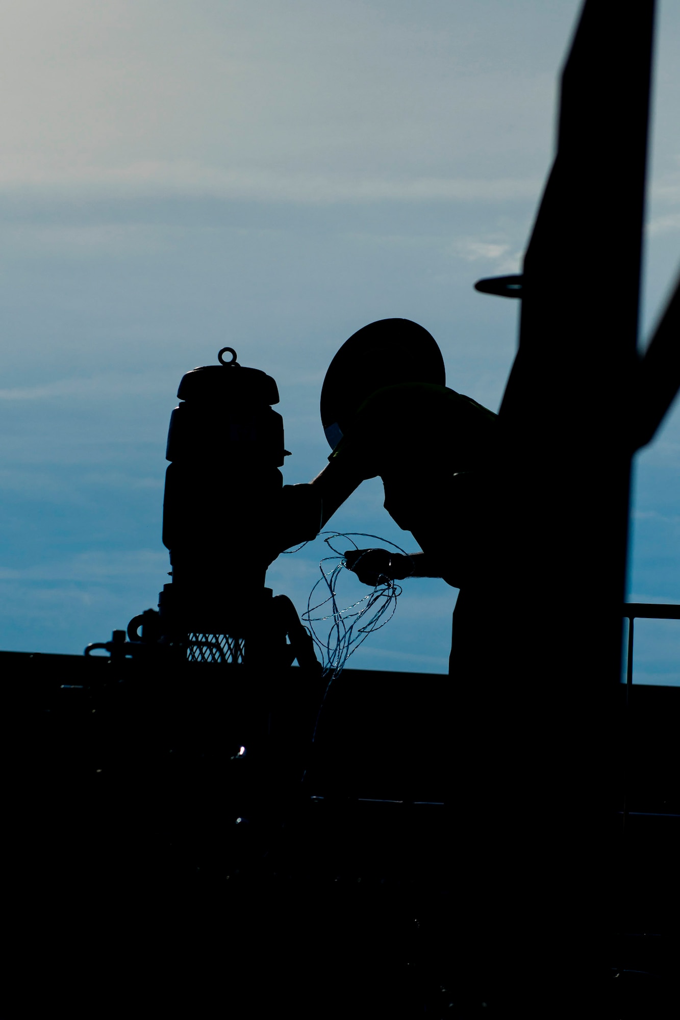 Paul Brown, a civilian electrician, receives wiring from construction workers for a fuel transfer pump in the 23d Logistics Readiness Squadron (LRS) fuel yard, July 18, 2018, at Moody Air Force Base, Ga. For the first time since the 1950s, the 23d LRS modernizing the yard to improve fuel efficiency to enhance operations. (U.S. Air Force photo by Airman 1st Class Erick Requadt)