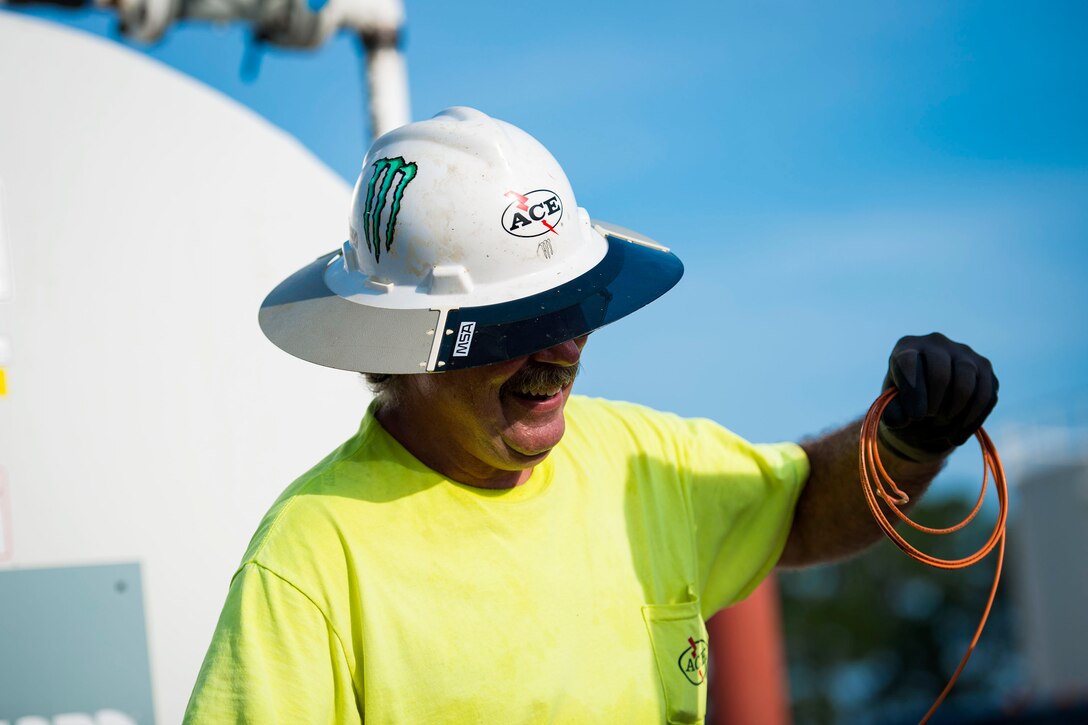 Kevin Yohe, construction superintendent, pulls wire to feed to the fuel-transfer pump in the 23d Logistics Readiness Squadron (LRS) fuel yard, July 18, 2018, at Moody Air Force Base, Ga.  For the first time since the 1950s, the 23d LRS is modernizing the yard to improve fuel efficiency to enhance operations. (U.S. Air Force photo by Airman 1st Class Erick Requadt)