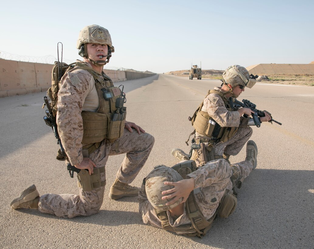 U.S. Marine Cpt. Jared Picard and Petty Officer 1st Class Alberto Servillaparra, from Task Force Lion establish a 360 degree security around a simulated casualty during a training exercise on Al Asad Airbase, Iraq, July 5, 2018. There are 75 Coalition partners committed to the goal of eliminating the threat posed by ISIS in Iraq and Syria and have contributed in various capacities to the effort. (U.S. Army photo by Sgt. Zakia Gray)