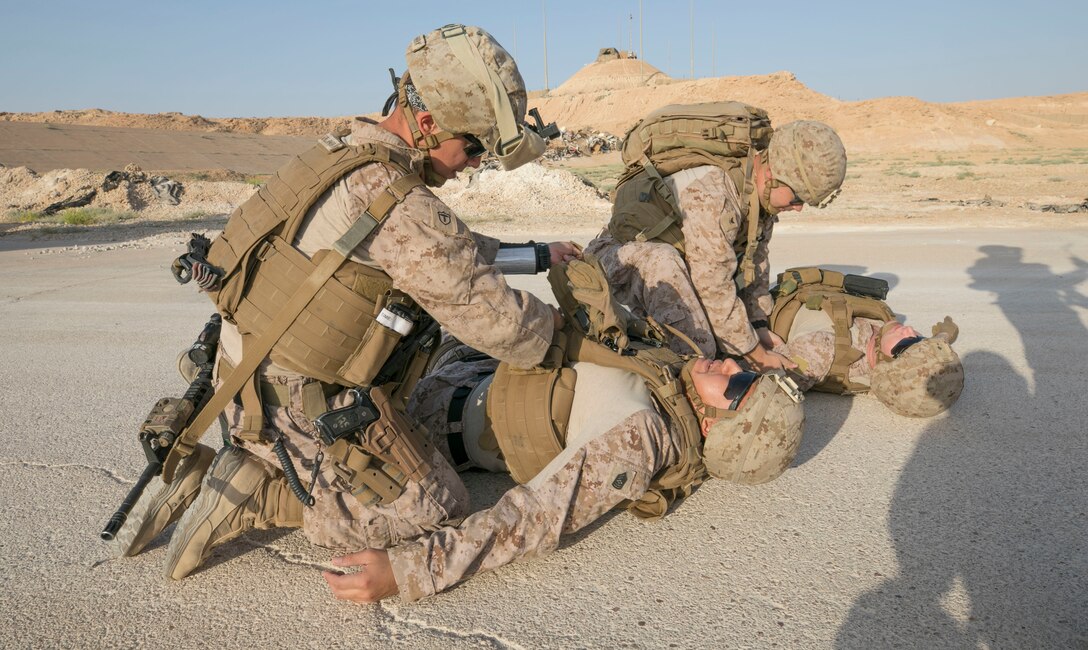 U.S. Navy corpsman Petty Officer 1st Class Alberto Sevillaparra and Petty Officer 3rd Class Evans Bolton, access wounded Marines during a training exercise on Al Asad Airbase, Iraq, July 5, 2018. There are 75 Coalition partners committed to the goal of eliminating the threat posed by ISIS in Iraq and Syria and have contributed in various capacities to the effort. (U.S. Army photo by Sgt. Zakia Gray)