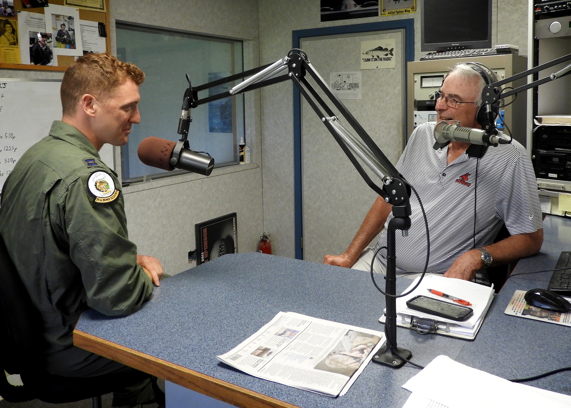 U.S. Air Force Capt. Eric Lipp, a B-2 pilot assigned to the 393d Bomb Squadron at Whiteman Air Force Base, shares with Marion “Woody” Woods, 1450 KOKO radio show host, how Lipp and his fellow Airmen saved a man’s life after an accident at Lake of the Ozarks. (U.S. Air Force photo by 2nd Lt. Allen Palmer)