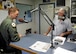 U.S. Air Force Capt. Eric Lipp, a B-2 pilot assigned to the 393d Bomb Squadron at Whiteman Air Force Base, shares with Marion “Woody” Woods, 1450 KOKO radio show host, how Lipp and his fellow Airmen saved a man’s life after an accident at Lake of the Ozarks. (U.S. Air Force photo by 2nd Lt. Allen Palmer)