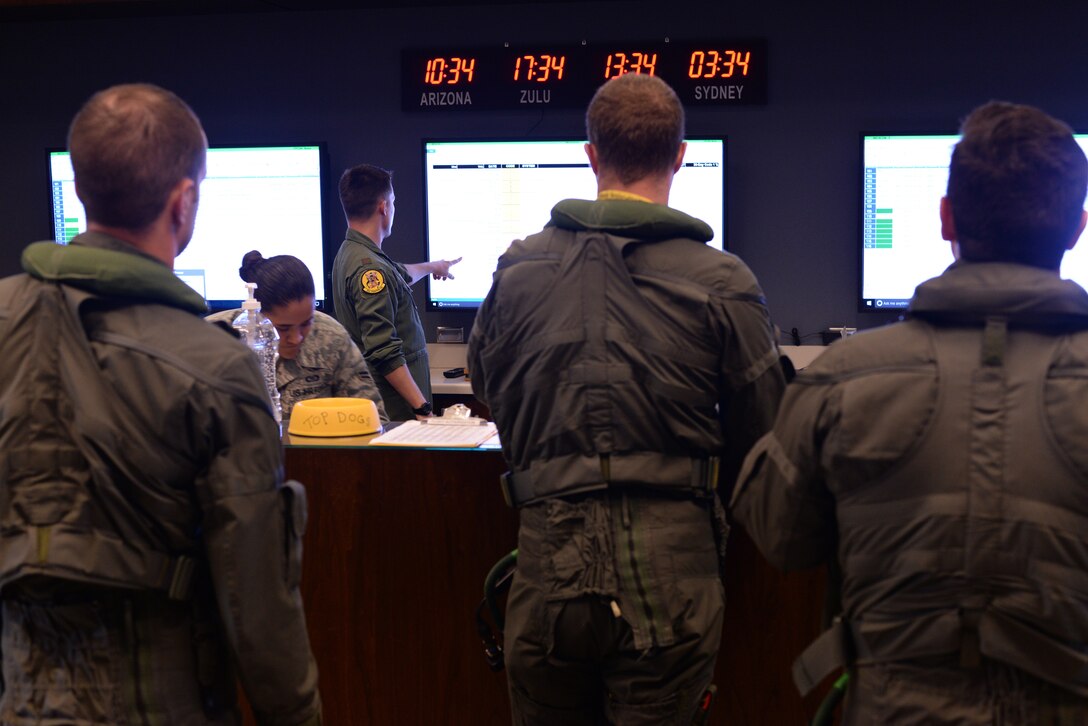 61st Fighter Squadron pilots, including Australians, brief at the operations desk before stepping to their F-35A Lightning IIs for a transitional training sortie July 18, 2018, at Luke Air Force Base, Ariz. Transitional training helps pilots experienced in flying other air frames adapt to the F-35. (U.S. Air Force photo by Senior Airman Ridge Shan)