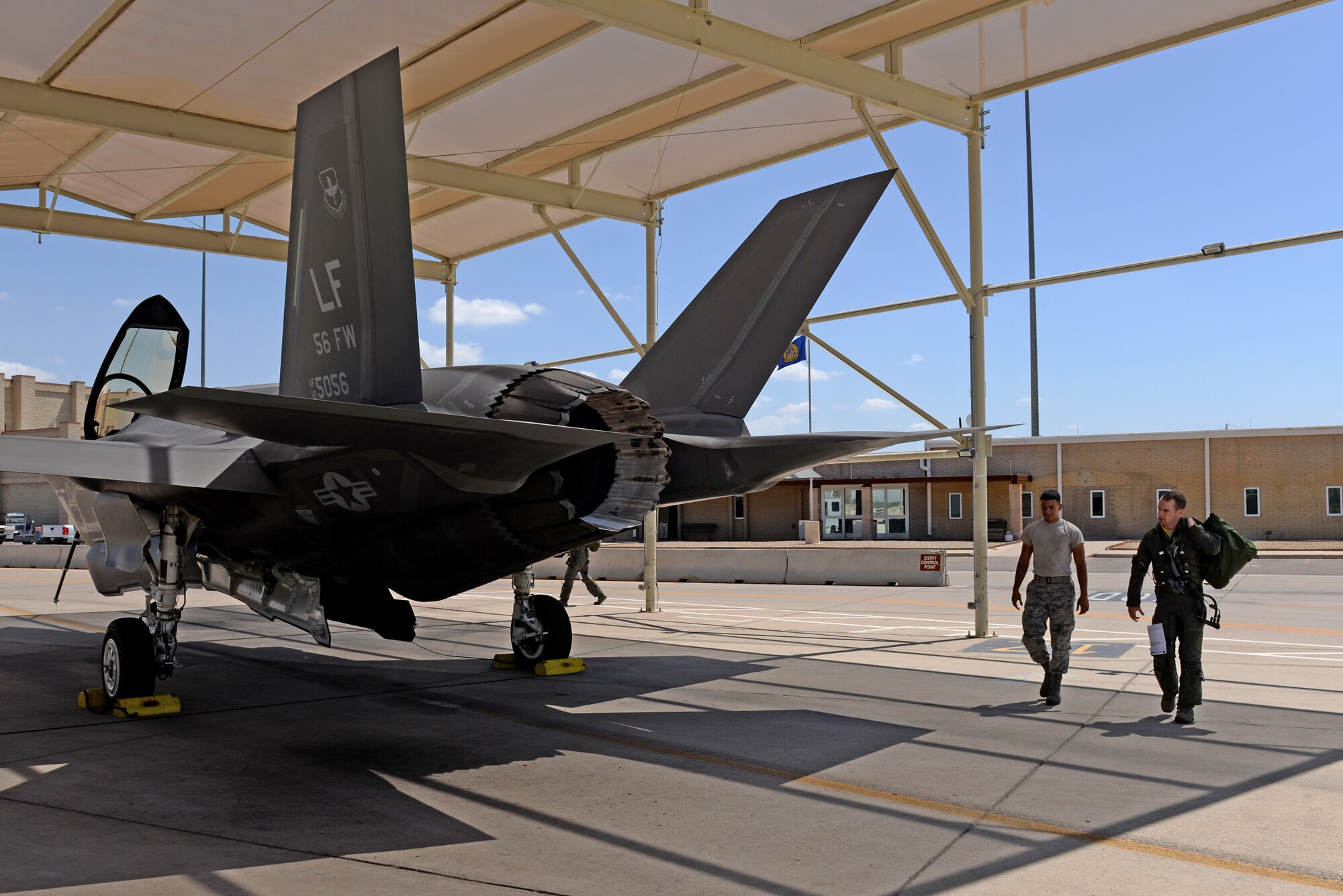 A 61st Fighter Squadron pilot walks with a 61st Aircraft Maintenance Unit maintainer out to their F-35A Lightning II for a transitional training sortie July 18, 2018, at Luke Air Force Base, Ariz. The sortie involved four instructor pilots training four students on basic flight maneuvers. (U.S. Air Force photo by Senior Airman Ridge Shan)