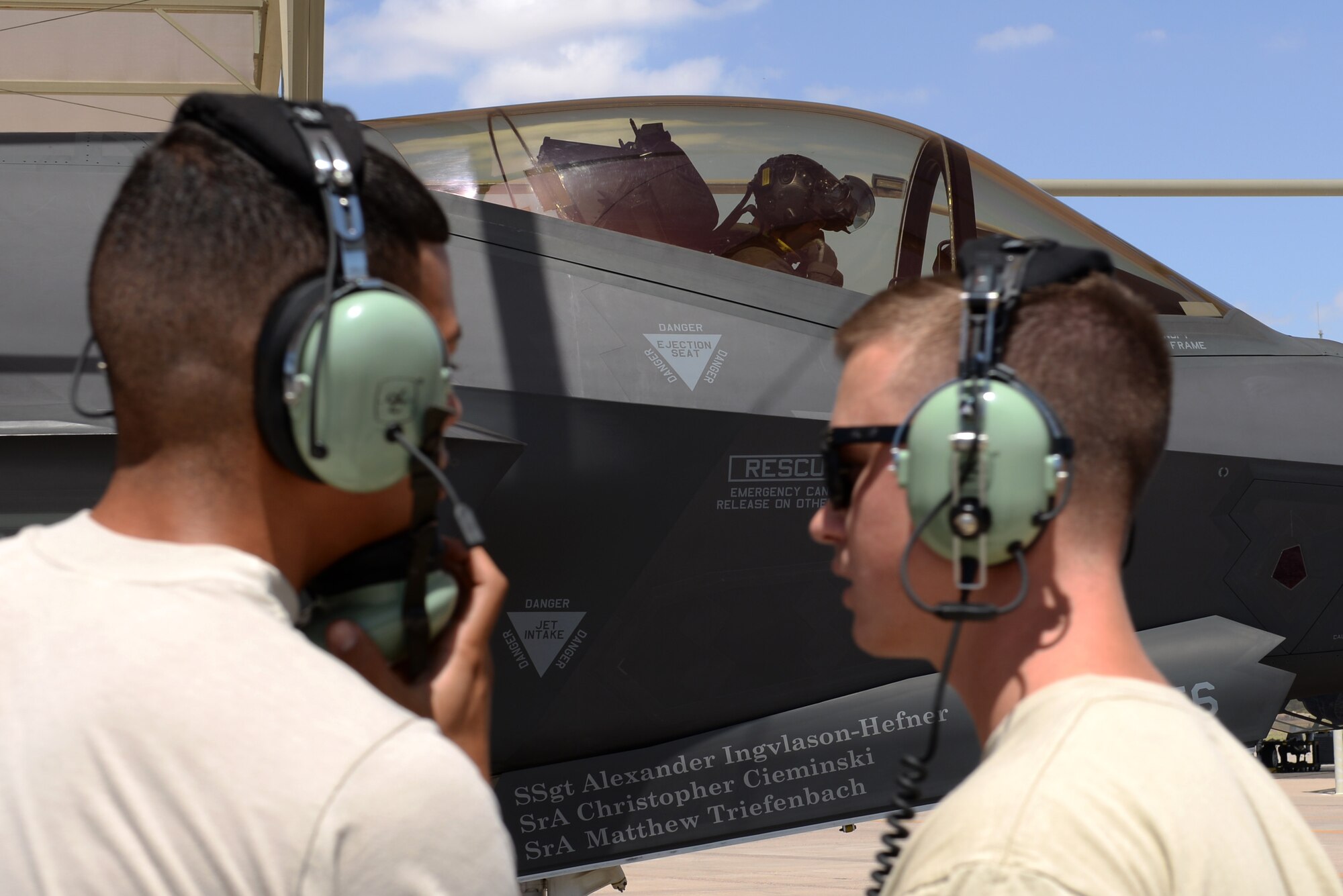 61st Aircraft Maintenance Unit maintainers discuss operations during pre-flight checks for an F-35A Lightning II July 18, 2018, at Luke Air Force Base, Ariz. Each fighter squadron has a corresponding aircraft maintenance unit. The 61st AMU services the jets of the 61st Fighter Squadron. (U.S. Air Force photo by Senior Airman Ridge Shan)