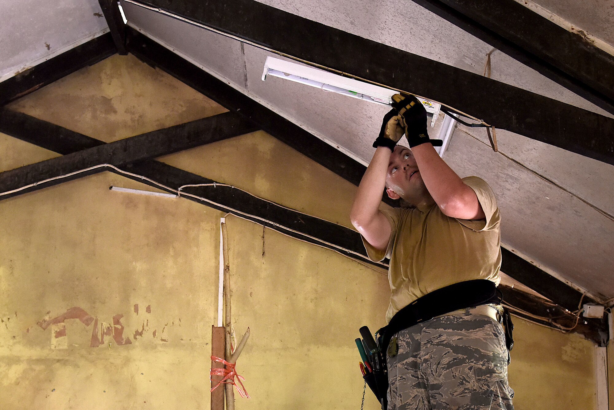 U. S. Air Force Staff Sgt. Nathan Henry, a structural journeyman with the 152nd Civil Engineer Squadron, Nevada Air National Guard, attaches a new light fixture inside one of the dormitories at Tata Primary and Secondary School during Pacific Angel 18-3 in Luganville, Espiritu Santo Island, Vanuatu, July 14, 2018.