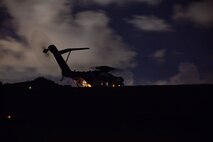 A CH-53E Super Stallion with Marine Heavy Helicopter Squadron 361 (HMH-361), 1st Marine Aircraft Wing, prepares to conduct night-time helicopter support team training July 13, 2018 at Kin Blue Training Area, Okinawa, Japan. HMH-361 uses CH-53E Super Stallion transport helicopters to transport Marines, equipment and cargo. (U.S. Marine Corps photo by Pfc. Mark Fike)