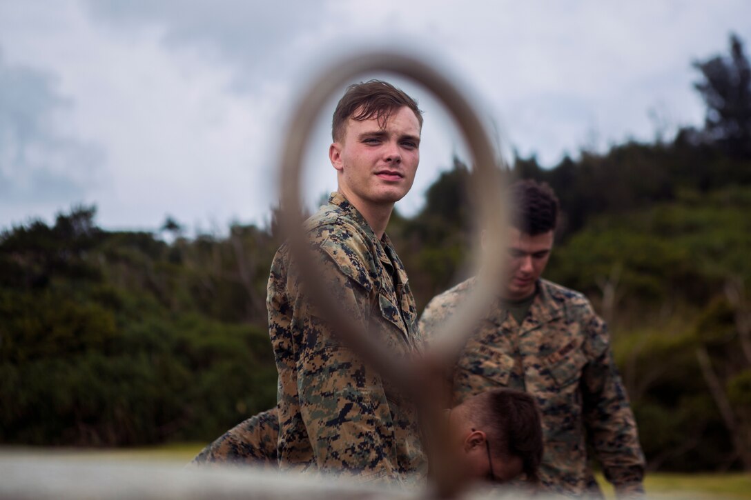 Lance Cpl. Tyler Duitsman, a landing support specialist with Landing Support Platoon, LS Company, 3rd Transportation Support Battalion, prepares a training block for helicopter support team operations July 13, 2018 at Kin Blue Training Area, Okinawa, Japan. The HST operations were held at night to train CH-53E Super Stallion pilots in night-flying certifications. Duitsman is a native of Waterloo, Iowa. (U.S. Marine Corps photo by Lance Cpl. Jamin M. Powell)