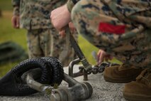 Lance Cpl. Levi King, a landing support specialist with Landing Support Platoon, Ls Company, 3rd Transportation Support Battalion, tapes a glow stick to the apex of a training block in preparation for helicopter support team operations July 13, 2018 at Kin Blue Training Area, Okinawa, Japan. The HST operations were held at night to train CH-53E Super Stallion pilots in Night-flying certifications. King is a native of Lebanon, Oregon. (U.S. Marine Corps photo by Lance Cpl. Jamin M. Powell)