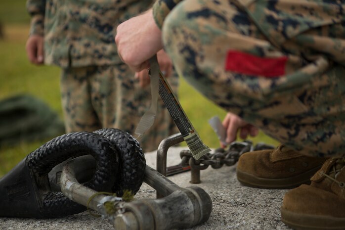 Lance Cpl. Levi King, a landing support specialist with Landing Support Platoon, Ls Company, 3rd Transportation Support Battalion, tapes a glow stick to the apex of a training block in preparation for helicopter support team operations July 13, 2018 at Kin Blue Training Area, Okinawa, Japan. The HST operations were held at night to train CH-53E Super Stallion pilots in Night-flying certifications. King is a native of Lebanon, Oregon. (U.S. Marine Corps photo by Lance Cpl. Jamin M. Powell)