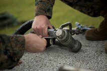 Lance Cpl. Tyler Duitsman, left, and Lance Cpl. Levi King, landing support specialists with Landing Support Platoon, LS Company, 3rd Transportation Support Battalion, tape a glow stick to the apex of a training block in preparation for Helicopter Support Team operations July 13, 2018 at Kin Blue Training Area, Okinawa, Japan. The HST operations were held at night to train CH-53E Super Stallion pilots in night-flying certifications. Duitsman is a native of Waterloo, Iowa. King is a native of Lebanon, Oregon. (U.S. Marine Corps photo by Lance Cpl. Jamin M. Powell)