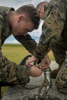 Lance Cpl. Tyler Duitsman, left, and Lance Cpl. Levi King, landing support specialists with Landing Support Platoon, LS Company, 3rd Transportation Support Battalion, tape a glow stick to the apex of a training block in preparation for Helicopter Support Team operations July 13, 2018 at Kin Blue Training Area, Okinawa, Japan. The HST operations were held at night to train CH-53E Super Stallion pilots in night-flying certifications. Duitsman is a native of Waterloo, Iowa. King is a native of Lebanon, Oregon. (U.S. Marine Corps photo by Lance Cpl. Jamin M. Powell)