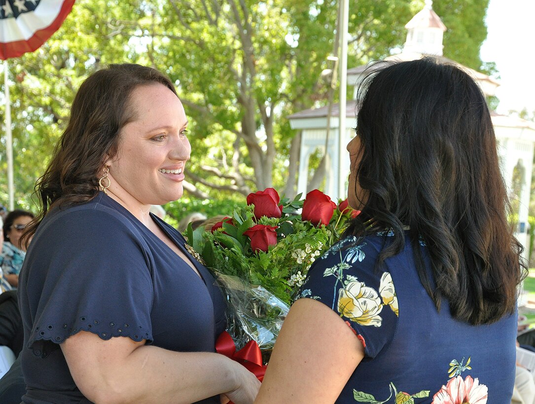 Kim Gibbs, wife of Col. Kirk Gibbs, outgoing U.S. Army Corps of Engineers Los Angeles District commander, receives flowers during a July 19 change of command ceremony at Fort MacArthur in San Pedro, California.