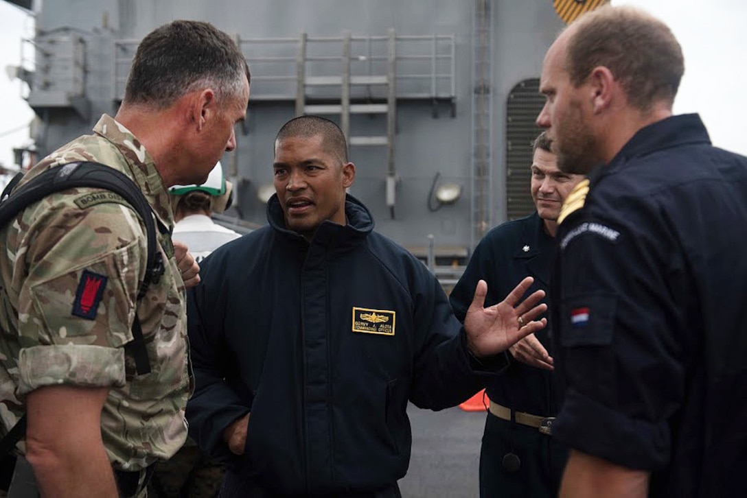 U.S., Royal Navy, and Netherlands commanders meet aboard the USS Harpers Ferry.