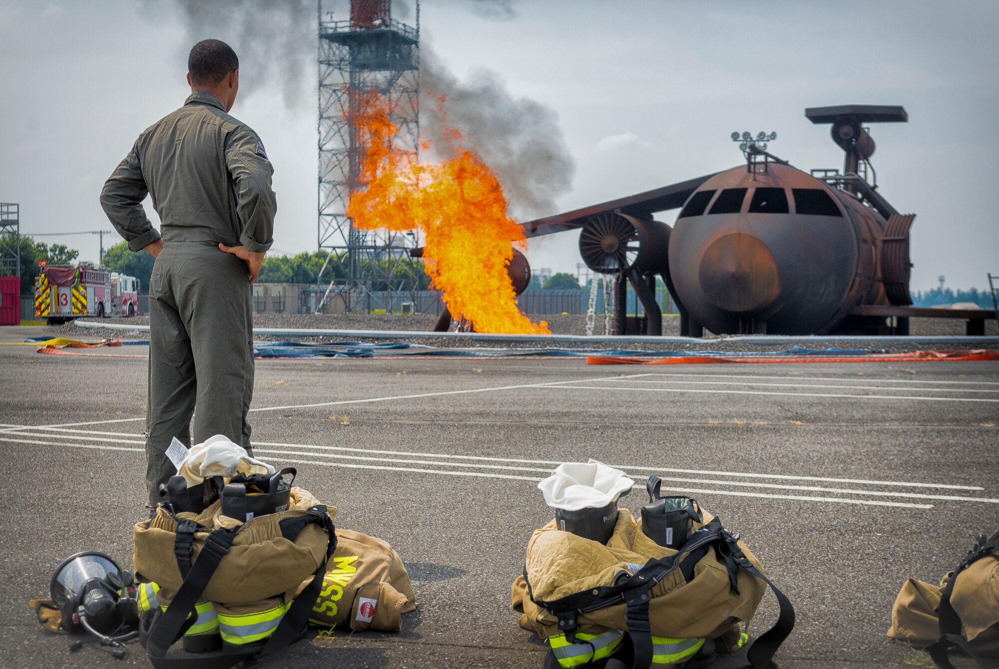 Lance Cpl. Christian Cozart, Marine Wing Support Squadron 171 Aircraft Rescue and Fire-Fighting specialist, watches a simulated aircraft burn