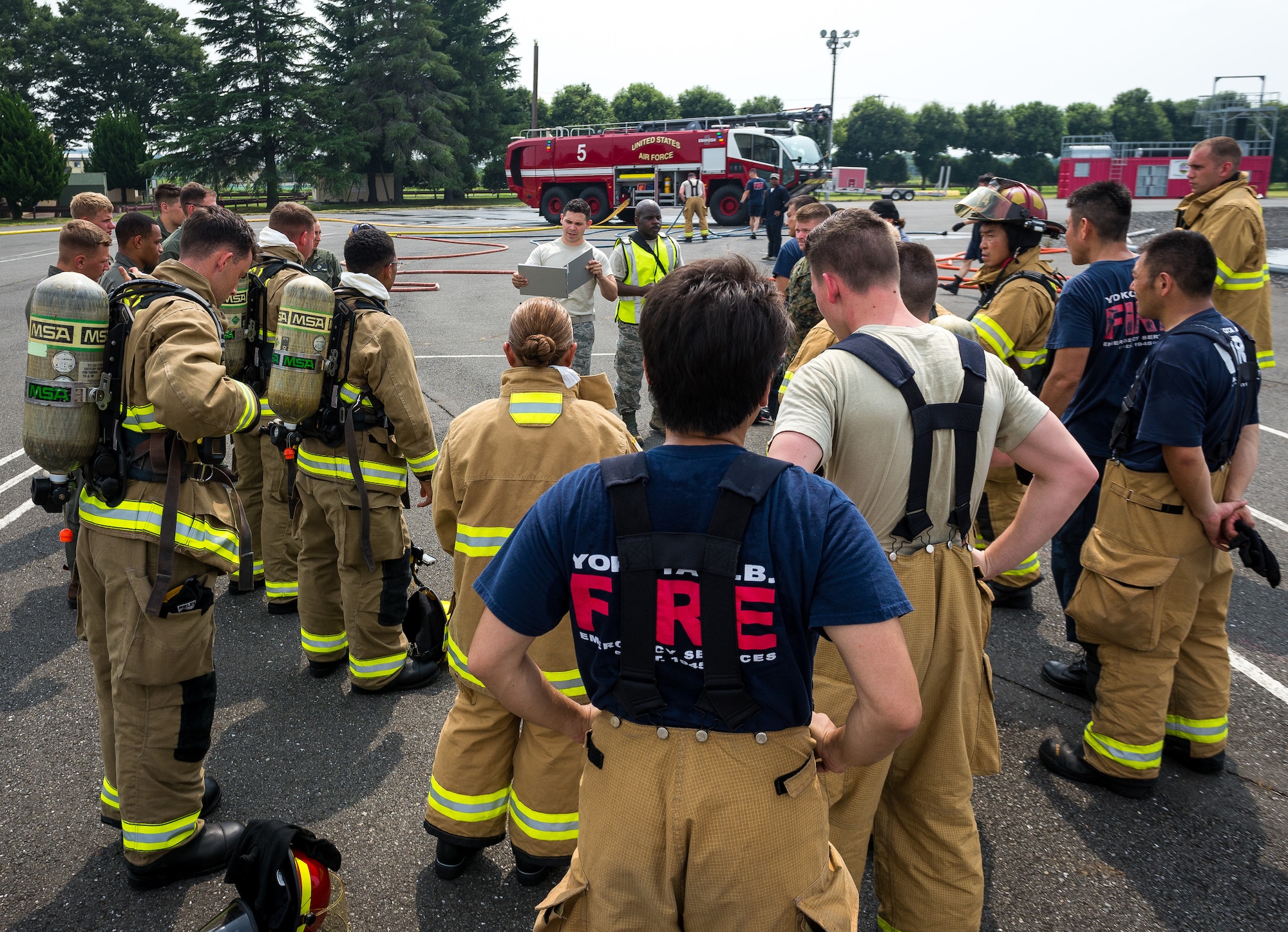 Yokota Air Base and Marine Corps Air Station Iwakuni firefighters receive a brief