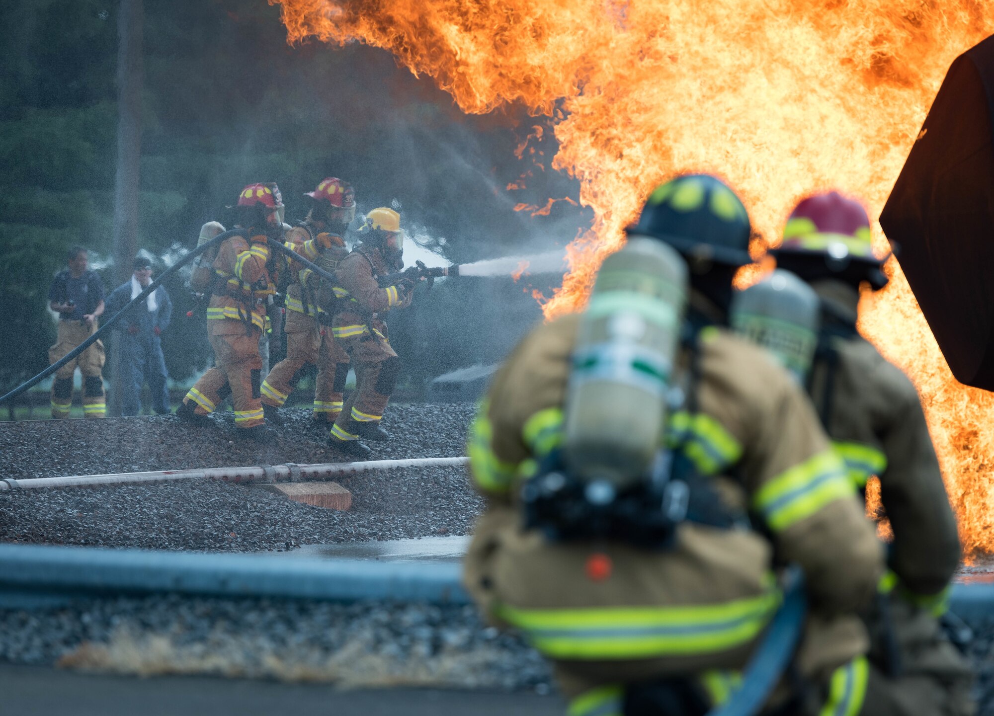Yokota Air Base and Marine Corps Air Station Iwakuni firefighters battle a simulated aircraft fire