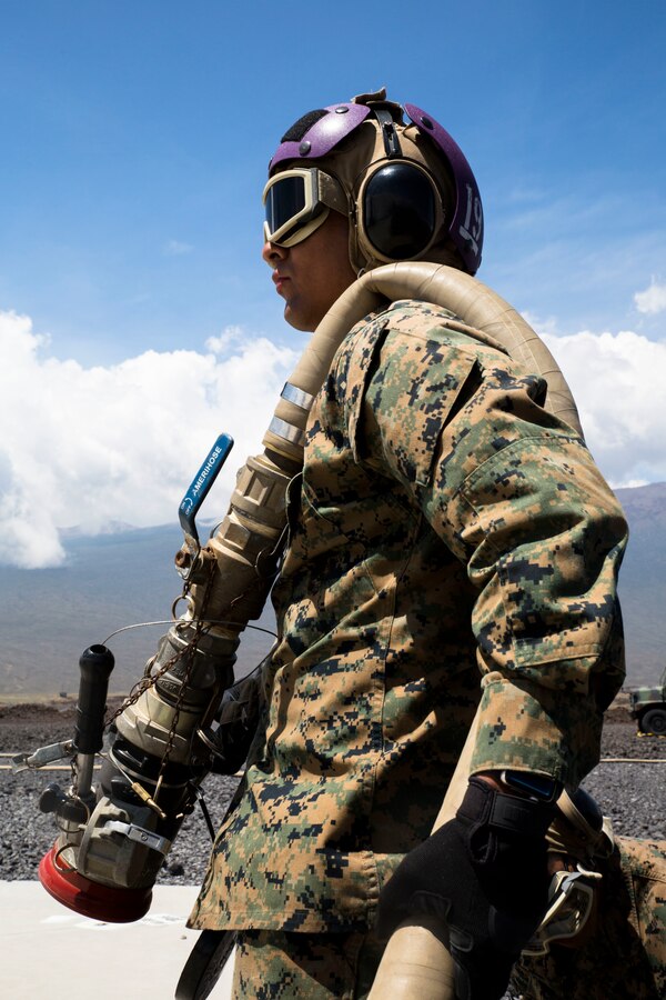 U.S. Marine Corps Lance Cpl. Alexjandro Sanchez-Delarosa, a bulk fuel specialist with Marine Wing Support Detachment 24, stands by to fuel a helicopter at a forward arming and refueling point during a field test for an Expeditionary Mobile Fuel Additization Capability system as part of Rim of the Pacific (RIMPAC) exercise at Pohakuloa Training Area, Hawaii, July 18, 2018. RIMPAC provides high-value training for task-organized, highly capable Marine Air-Ground Task Force and enhances the critical crisis response capability of U.S. Marines in the Pacific.