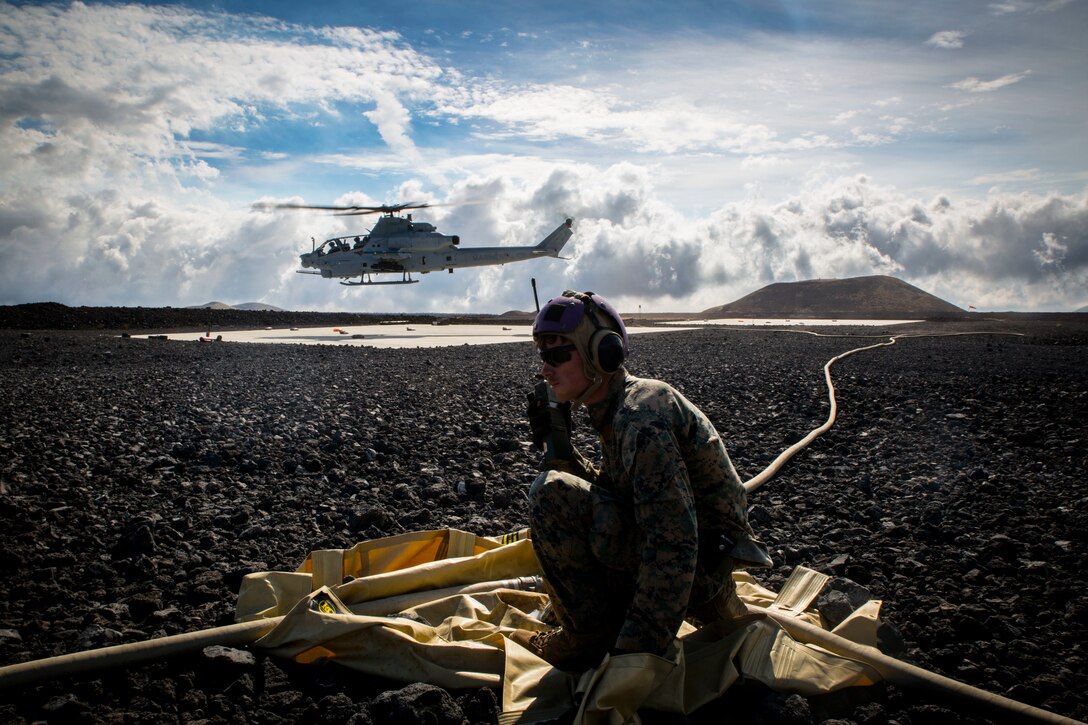 U.S. Marine Cpl. Michael Michehl, a line noncommissioned officer with Marine Wing Support Detachment 24, controls forward arming and refueling point operations after refueling a Bell AH-1W Super Cobra during a field test for the Expeditionary Mobile Fuel Additization Capability system as part of Rim of the Pacific (RIMPAC) exercise at Pohakuloa Training Area, Hawaii, July 18, 2018. RIMPAC provides high-value training for task-organized, highly capable Marine Air-Ground Task Force and enhances the critical crisis response capability of U.S. Marines in the Pacific.