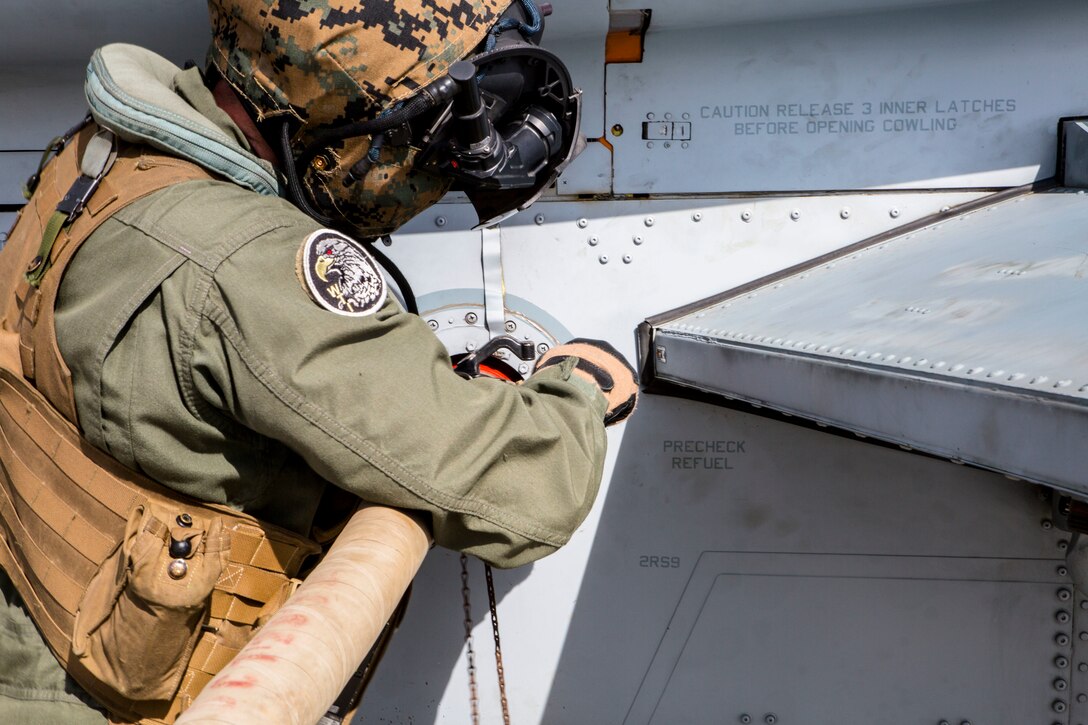 A U.S. Marine attaches a fuel hose to a Bell AH-1W Super Cobra helicopter during a field test for an Expeditionary Mobile Fuel Additization Capability system as part of Rim of the Pacific (RIMPAC) exercise at Pohakuloa Training Area, Hawaii, July 18, 2018. RIMPAC provides high-value training for task-organized, highly capable Marine Air-Ground Task Force and enhances the critical crisis response capability of U.S. Marines in the Pacific.