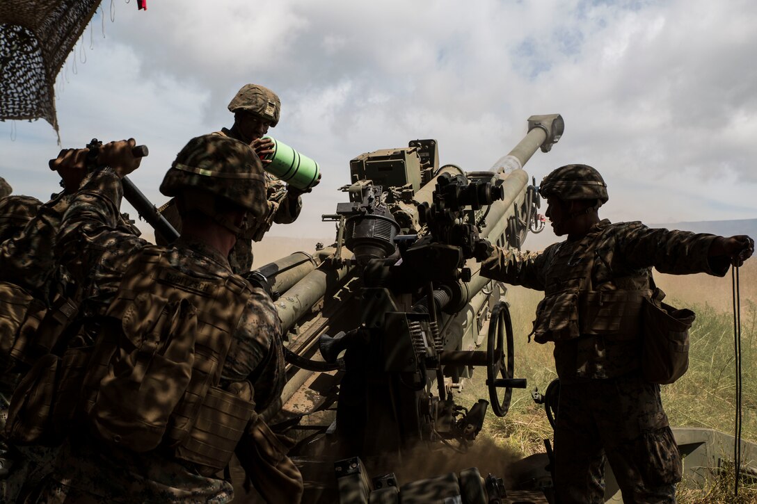 U.S. Marines with Bravo Battery, 1st Battalion, 12th Marine Regiment, load high-explosive round in a M777 towed 155 mm howitzer during live-fire training as part of Rim of the Pacific (RIMPAC) exercise at Pohakuloa Training Area, Hawaii, July 17, 2018. RIMPAC provides high-value training for task-organized, highly capable Marine Air-Ground Task Force and enhances the critical crisis response capability of U.S. Marines in the Pacific.