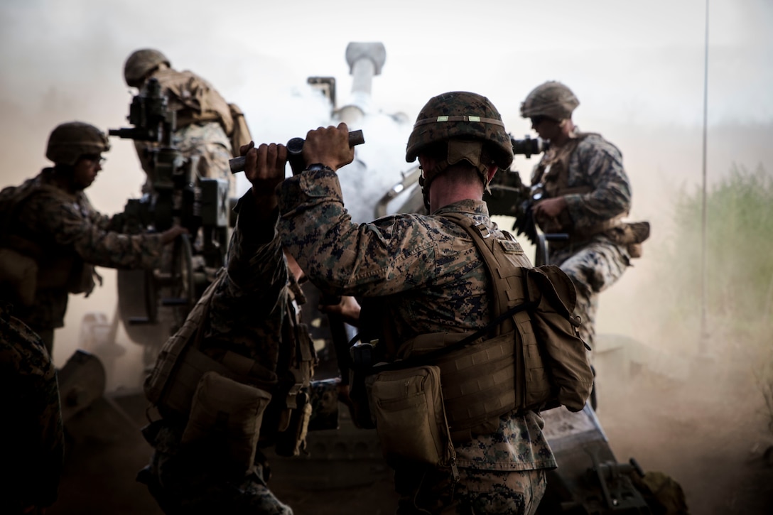 U.S. Marines with Bravo Battery, 1st Battalion, 12th Marine Regiment, use a ramrod to push a round into a M777 towed 155 mm howitzer during live-fire training as part of Rim of the Pacific (RIMPAC) exercise at Pohakuloa Training Area, Hawaii, July 17, 2018. RIMPAC provides high-value training for task-organized, highly capable Marine Air-Ground Task Force and enhances the critical crisis response capability of U.S. Marines in the Pacific.