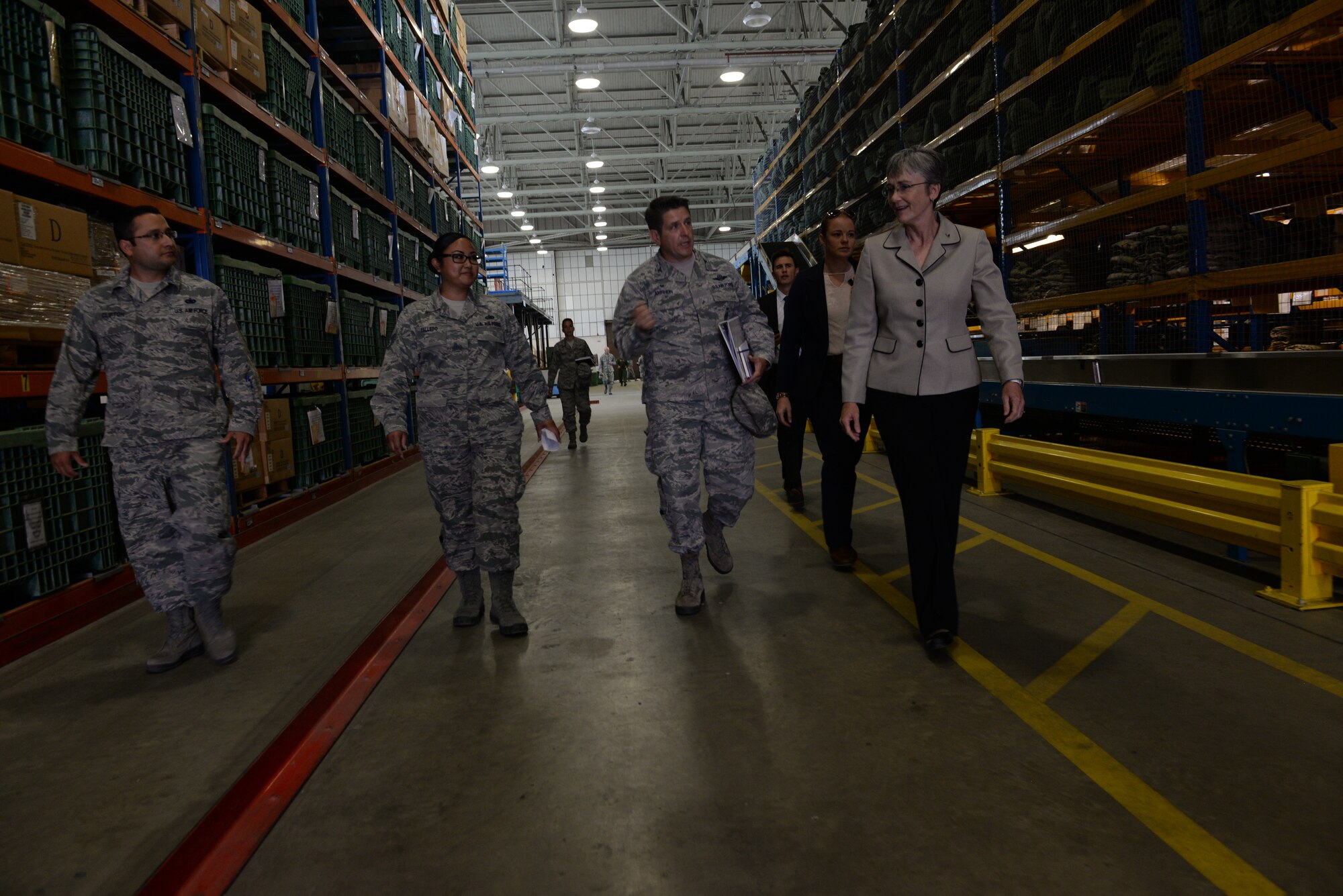 U.S. Air Force Tech. Sgt. Noah Clifton, left, 100th Logistics Readiness Squadron NCO in charge of individual protective equipment, Staff Sgt. Tiani Talledo, 100th LRS flight service center supervisor, Col. Christopher Amrhein 100th Air Refueling Wing commander, and Secretary of the Air Force Heather Wilson discuss the updated operations in the 100th LRS warehouse at RAF Mildenhall, England on July 12, 2018. Secretary Wilson visited RAF Mildenhall to engage with Airmen from the 100th ARW and discuss innovations and strategy. (U.S. Air Force photo by Airman 1st Class Alexandria Lee)