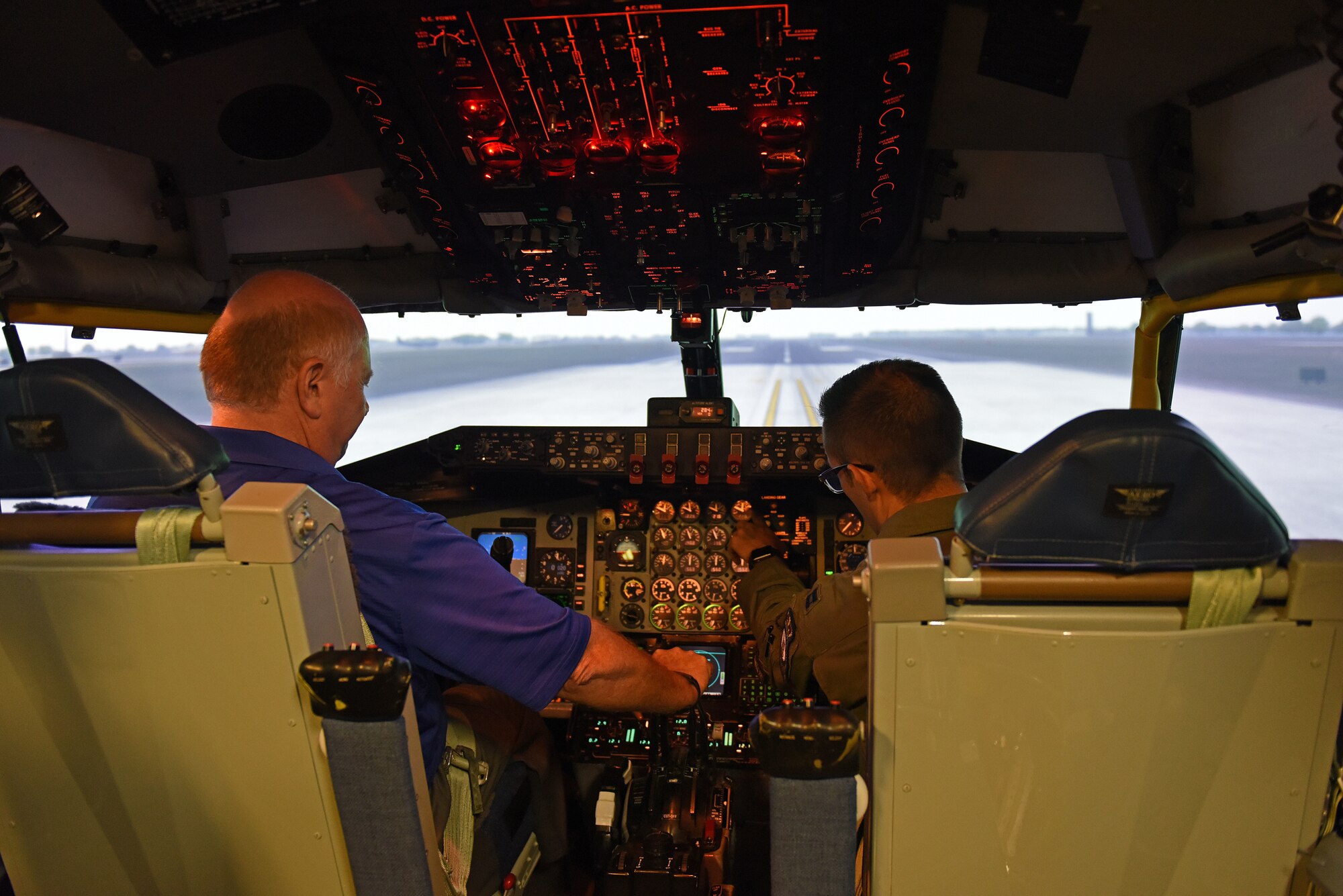 U.S. Air National Guard Col. (ret.) Jay Hone, left, flies on a KC-135 Stratotanker simulator alongside U.S. Air Force Capt. Dustin Haynes, 351st Air Refueling Squadron pilot, during his visit to RAF Mildenhall, England, July 12, 2018. Hone is the husband of Secretary of the Air Force Heather Wilson. During his time at RAF Mildenhall he met with Airmen and visited different support agencies on base for Airmen and their families. (U.S. Air Force photo by Senior Airman Luke Milano)