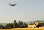 Oregon Army National Guard Soldiers with 1st Battalion, 168th Aviation Regiment, land a CH-47 Chinook helicopter for refueling at Davis helibase near Gates, Oregon, August 7, 2017. Some Guard crews and helicopters have been mobilized this week to assist in wildfire suppression efforts in the state.